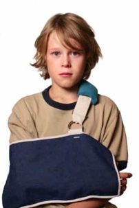 Young boy with left arm in a sling